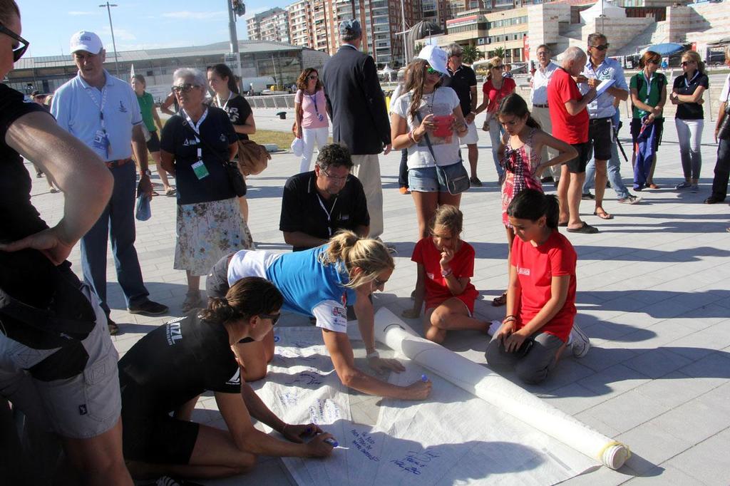 470 medallists signing sail before medal ceremony - 2014 ISAF Sailing World Championships Santander © Sail-World.com http://www.sail-world.com